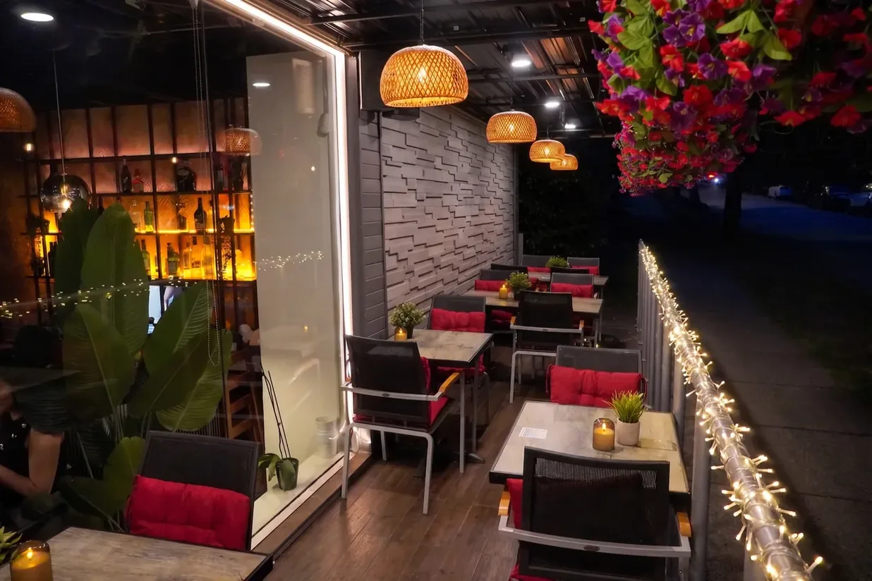 Patio seating framed by string lights